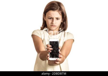 angry little girl holding an phone with broken screen in sudio Stock Photo