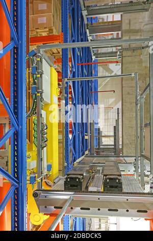 Automated Storage and Retrieval System Shuttle Robotic Forks in Warehouse Stock Photo