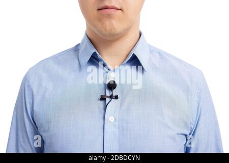 interview or broadcasting concept - close up of small lavalier microphone on male shirt Stock Photo