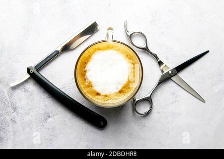 Men's Grooming Tools. Barber Equipment And Supplies Dangerous razor, coffe and scissors on marable background. Top views, close-up. Stock Photo