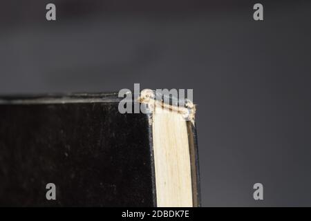 The binding of an old book in black cover. Stock Photo