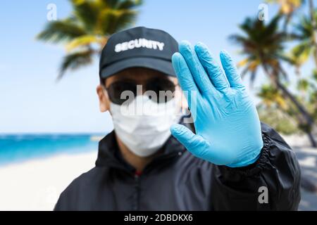 Security Guard Making Hand Stop Gesture At The Beach Stock Photo