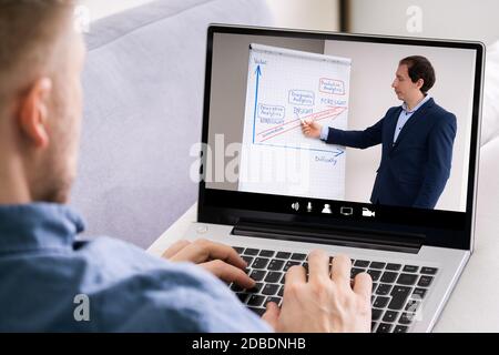 Man Participating In Online Coaching Session Using Laptop Stock Photo