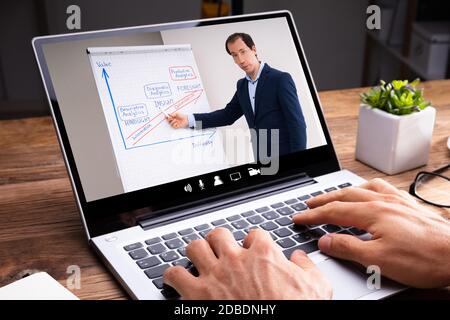 Man Participating In Online Coaching Session Using Laptop Stock Photo