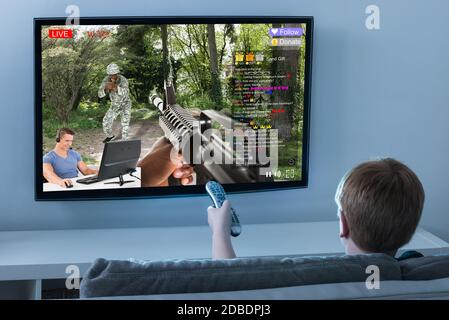 Kid Watching Live Game Streaming Session On TV Screen Stock Photo