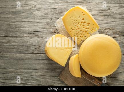 Various types of cheese on rustic wooden table. Top view. Free space for text. Stock Photo