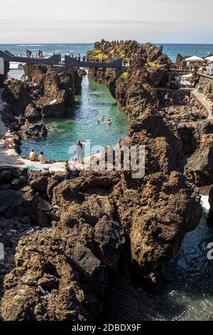 Porto Moniz, Madeira, Portugal - April 18, 2018: Natural rock pool of Porto Moniz on Madeira Island. Portugal.  It is a public bath with water from th Stock Photo