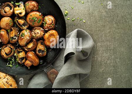 Fresh mushrooms Cooking in pan. Healthy meal with roasted champignon. Healthy vegetable dishes meal. Stock Photo