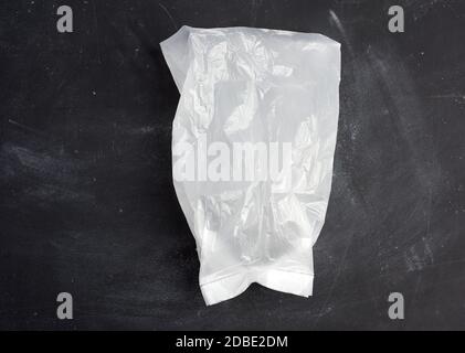 white transparent plastic bag for products on a black background, top view Stock Photo