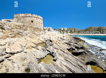 Fortress of Moraira located on the rocky coast of Mediterranean Sea. Sunny summer day, no people. Costa Blanca, Province of Alicante, Spain Stock Photo