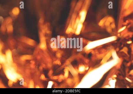 Blurred golden foil glowing texture. Defocused background. Stock Photo
