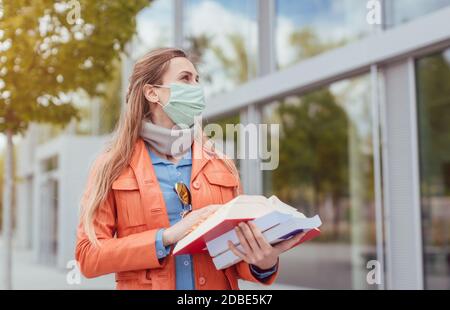 Student wearing mask during covid-19 cannot enter closed university building Stock Photo