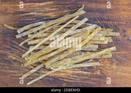 Dried salted tuna elite snack on wooden background. Snack Fish to beer. Close up. Stock Photo