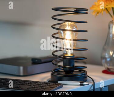 Vintage Iron Spiral Lamp in modern Home Office Environment Close-up View Stock Photo