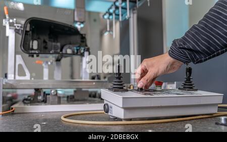 quality engineer controls an instrument for 3D measurement of plastic castings in the automotive industry. Stock Photo