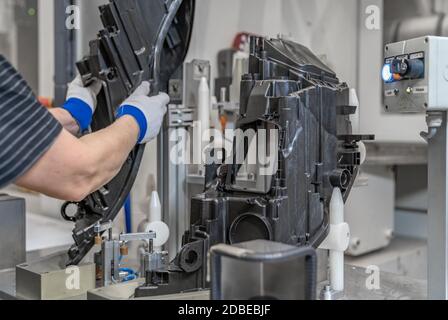 assembly of plastic molds on the production line in the factory. Stock Photo