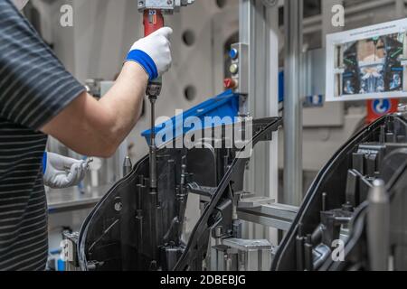 assembly of plastic molds on the production line in the factory. Stock Photo
