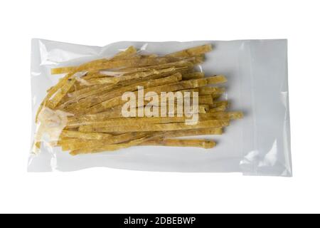 Dried salted tuna elite snack in a transparent package appetizer to beer isolated on white background. Snack Fish to beer. Close up. Stock Photo