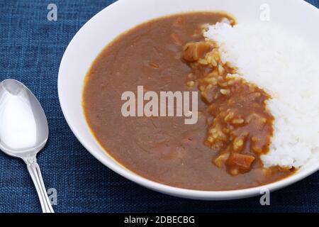 Close up of Japanese curry rice with spoon on table Stock Photo