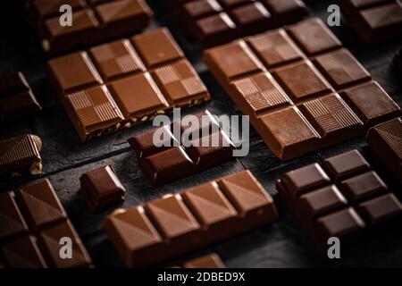 Milk and hazelnut chocolate bars on black background Stock Photo