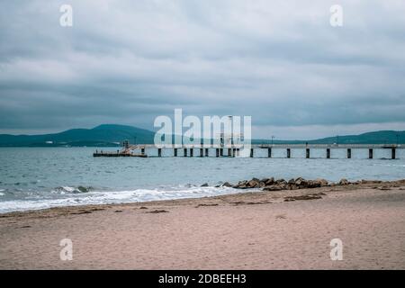 Sea bridge in Burgas, Bulgaria in winter autumn season. Grey white sky, gloomy day. Stock Photo