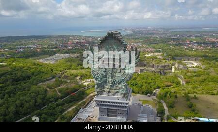 Landscape picture of tallest Garuda Wisnu Kencana GWK statue as Bali landmark with blue sky as a background. Balinese traditional symbol of hindu Stock Photo