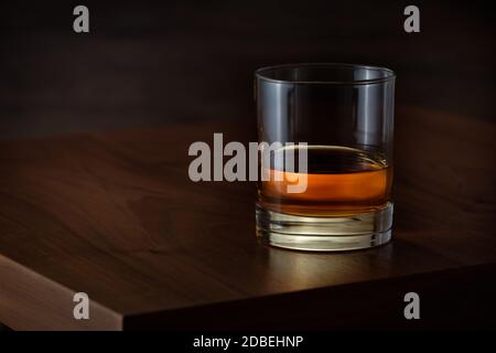 Tumbler glass with kentucky straigt bourbon whiskey on wooden tabel Stock Photo