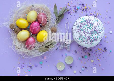 beautiful beautiful Easter composition in purple tones with painted eggs and cake Stock Photo