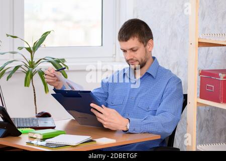 Business man reads a printed report in a folder Stock Photo