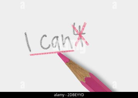 The phrase I can't corrected with pink pencil on white background - Concept of women and self belief Stock Photo