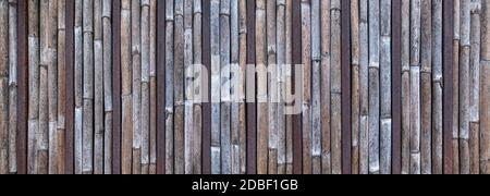 Panoramic wall made of bamboo cane and metal bars Stock Photo