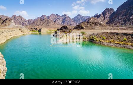 Scenic view of Hatta Lake and Hajar Mountains in the Emirate of Dubai, UAE Stock Photo