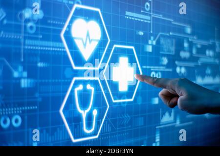 A hand presses healthcare concept on a futuristic display. Stock Photo