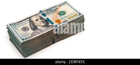 Isolated bundle of dollars. A large stack of hundred-dollar bills lies diagonally across the white background of the image. Close up. Full-contrast co Stock Photo