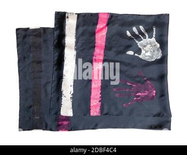 folded handcrafted black silk scarf with handpainted handprints isolated on white background Stock Photo
