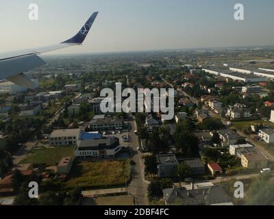 LOT Airlines B737-800 flight from London Heathrow to Warsaw,Poland approaches Chopin Airport,Warsaw as viewed from right hand passenger cabin window o Stock Photo