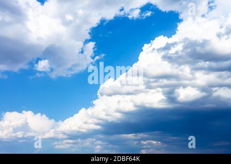 large rainy clouds in blue sky on sunny spring day Stock Photo