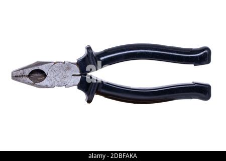 Pliers isolated. Close-up of an rusty well used metal combination pliers with black handle isolated on a white background. Macro photograph. Stock Photo