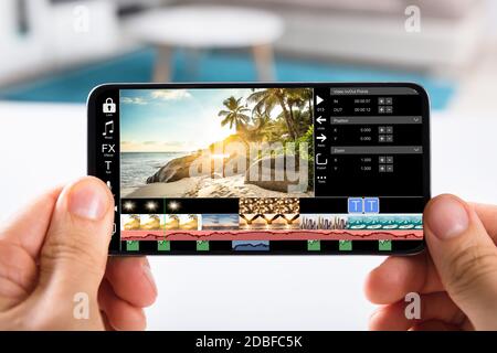 Editing Videos On Mobile Phone Using Video Editor App Stock Photo
