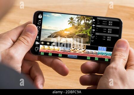 Editing Videos On Mobile Phone Using Video Editor App Stock Photo