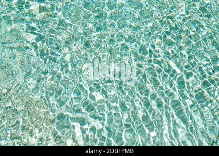 Ripple Water in swimming pool with sun reflection. Stock Photo