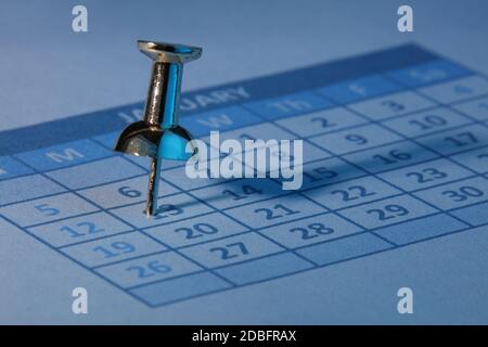 A push pin in calendar with blue light Stock Photo