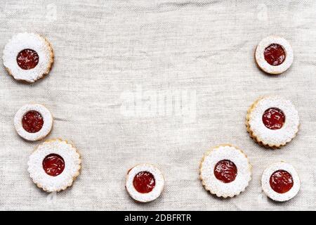 Christmas linzer cookies on light wrinkled tablecloth Stock Photo
