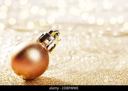 Gold decorative ball on bokeh shiny background. Stock Photo