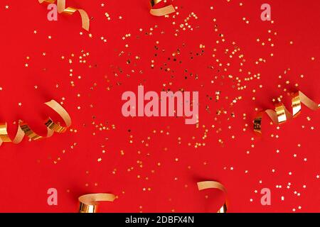 Golden swirls and star shaped sparkles on red Stock Photo