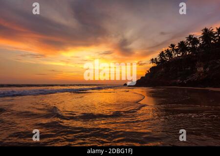 Sunset on Varkala beach popular tourist destination in Kerala state, South India Stock Photo