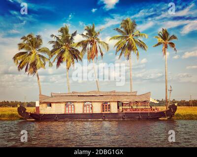 Kerala India tourism travel concept background - vintage retro effect filtered hipster style image of Houseboat on Kerala backwaters. Kerala, India Stock Photo