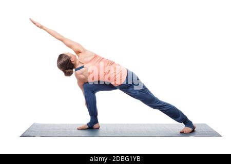 Young fit woman doing Ashtanga Vinyasa Yoga asana Parivritta parsvakonasana - revolved side angle pose isolated on white Stock Photo