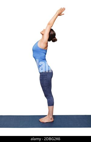 Woman doing Hatha Yoga asana Tadasana - Mountain pose with stretched hands  on yoga mat in studio on grey bagckground Stock Photo - Alamy