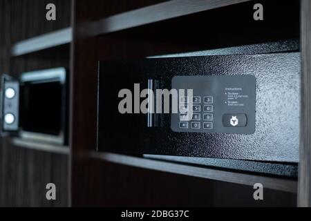Small safe in hotel room with digital code Stock Photo